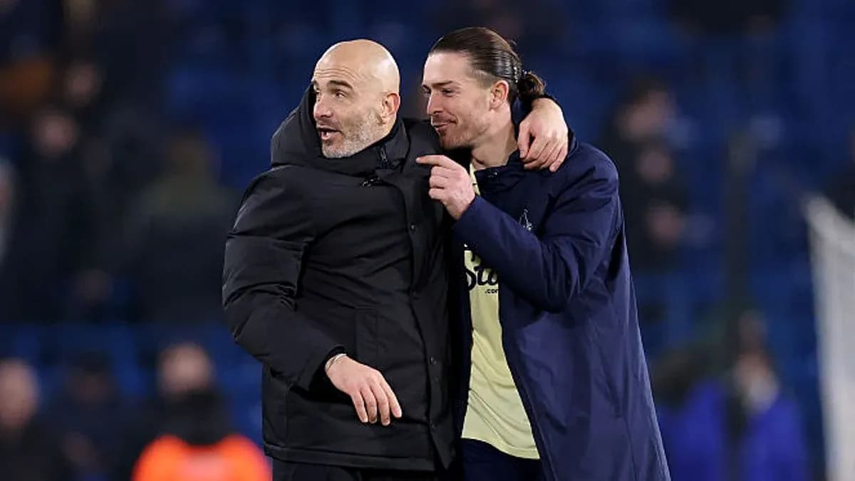 Two men embracing on football pitch after match