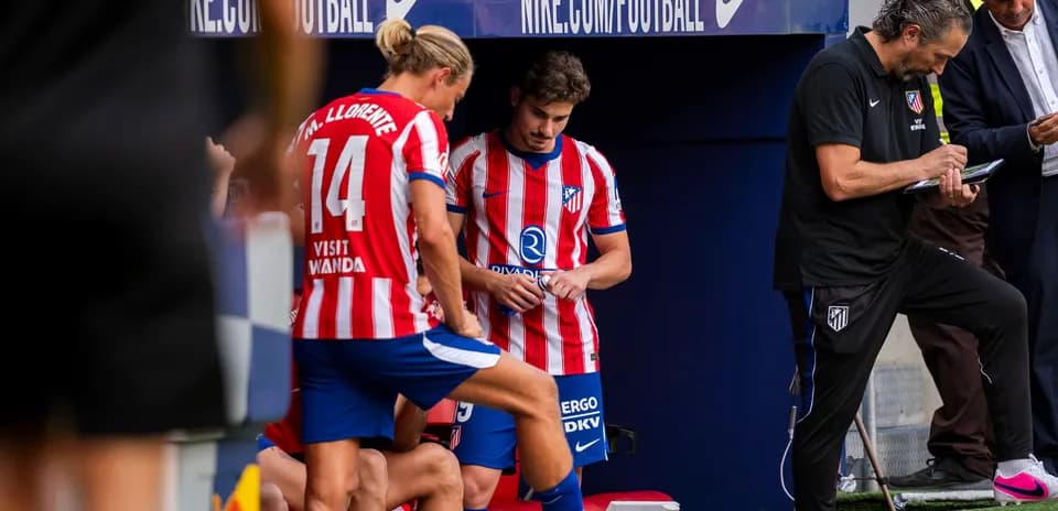 Atletico Madrid players and staff on the bench