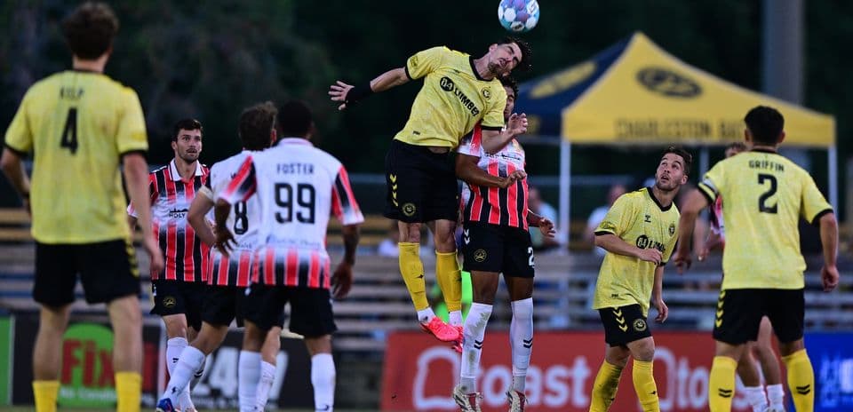 Players competing for the ball in Charleston Battery match