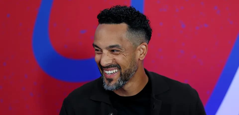 Man smiling against a colorful background