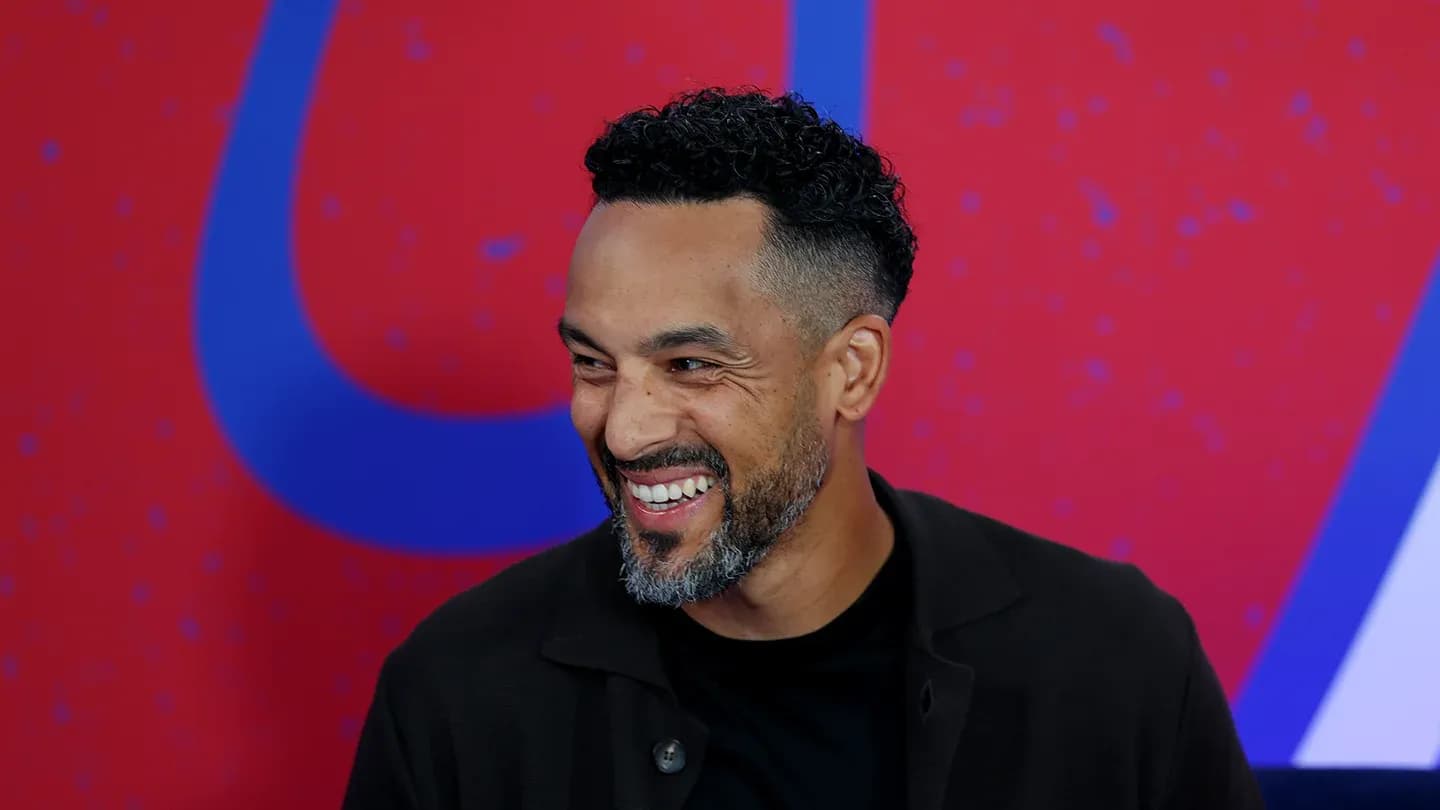 Man smiling against a colorful background