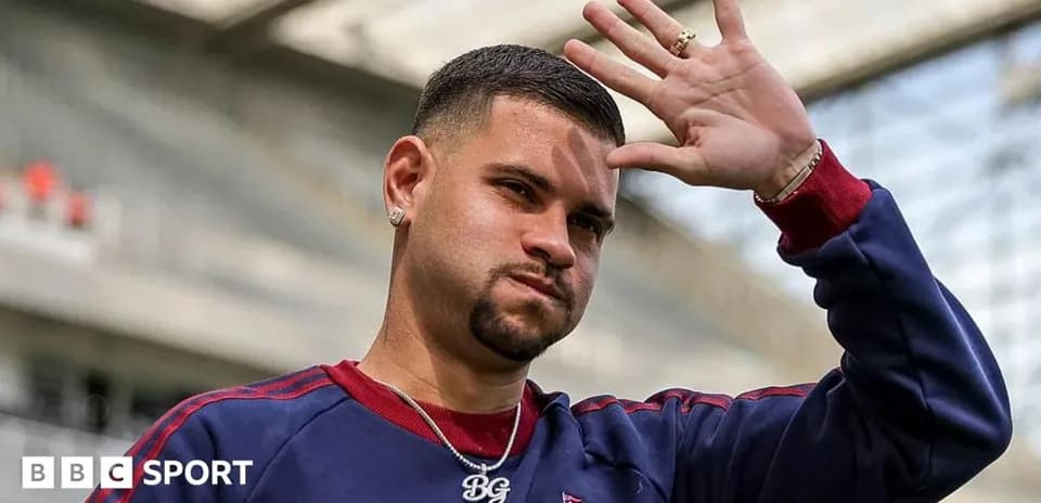 Player waving while wearing team training gear