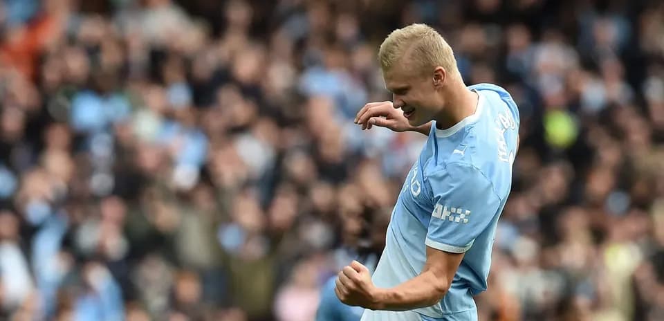 Player celebrating goal in front of cheering crowd