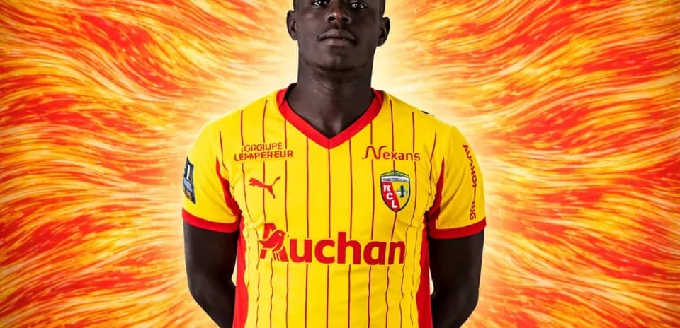 Player in yellow and red football jersey posing
