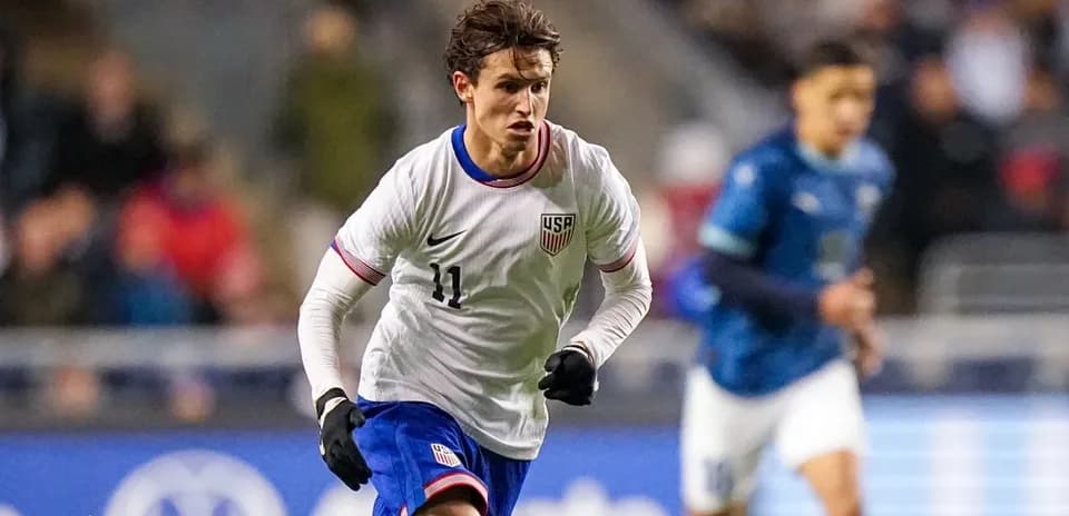 US player dribbling during international soccer match