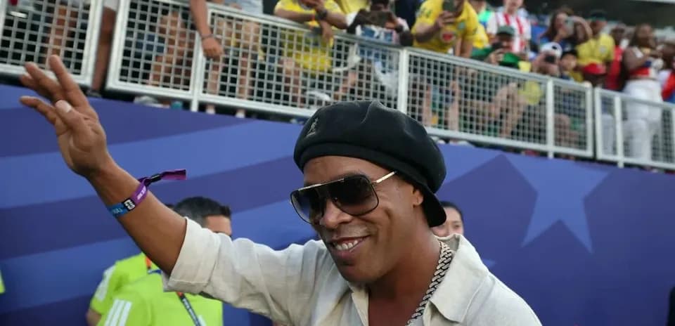 Man waving to fans at a sports event