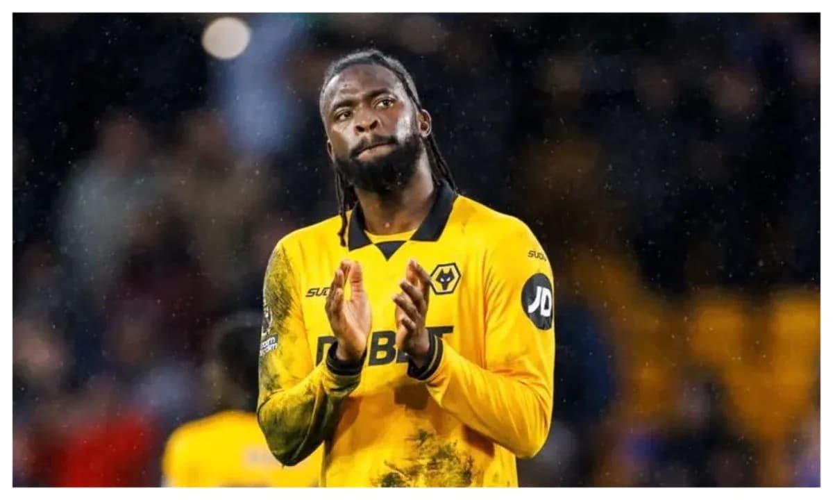 Player in yellow jersey applauding fans after match