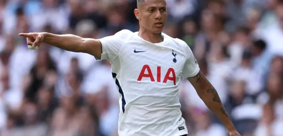Player pointing during match while wearing Tottenham kit