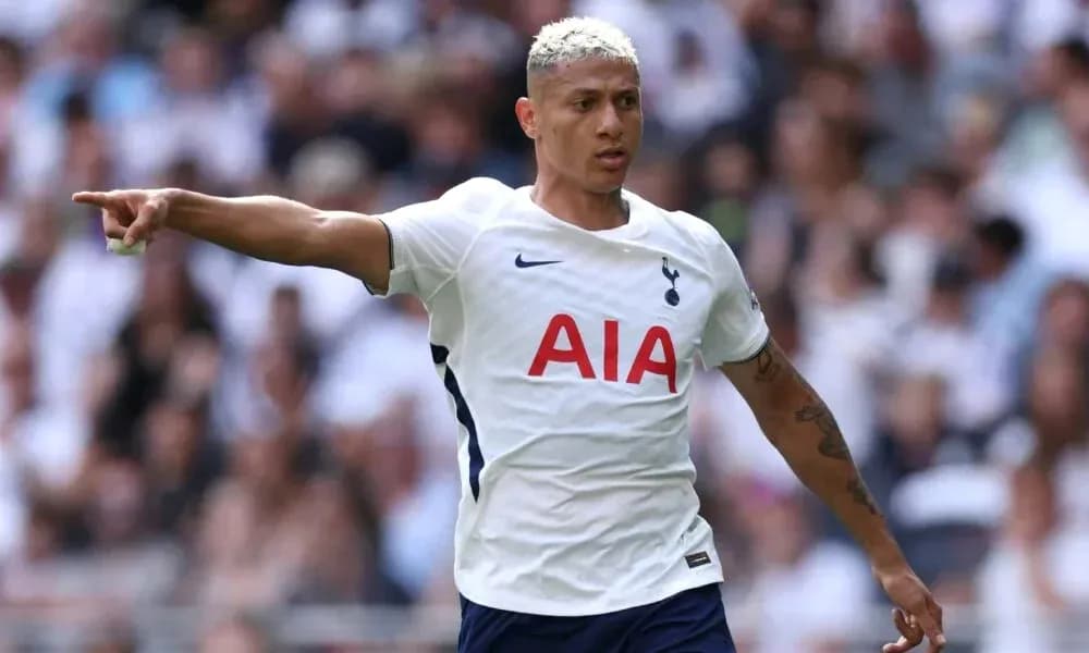 Player pointing during match while wearing Tottenham kit