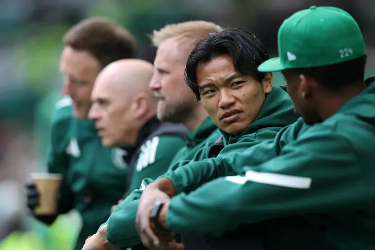 Coaches and players seated on the bench during match