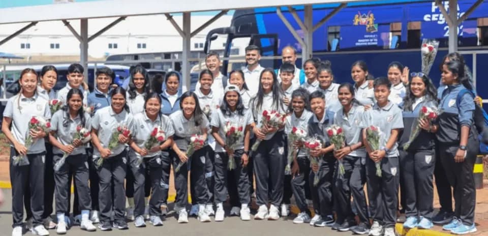 Women's sports team posing with roses at arrival