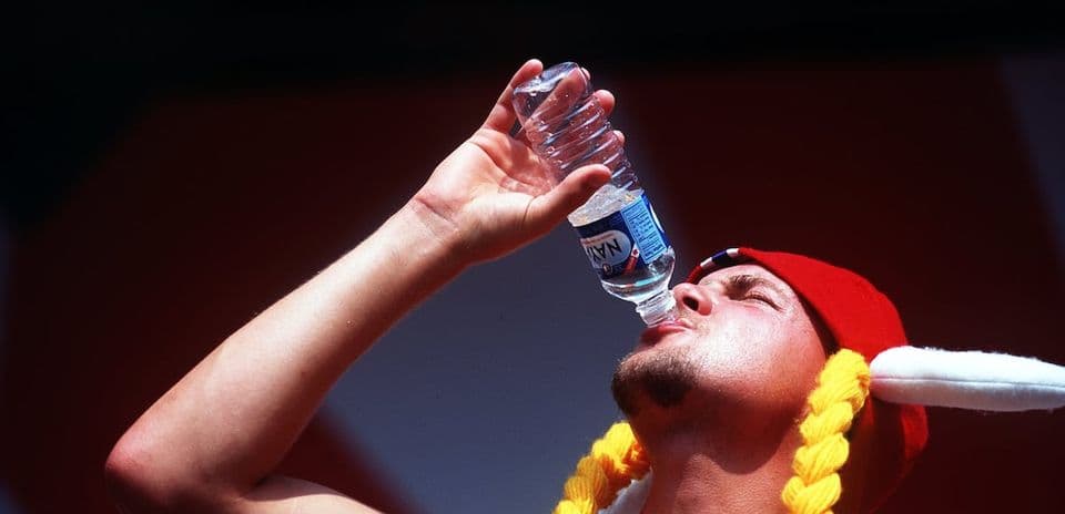 Person drinking water during outdoor event