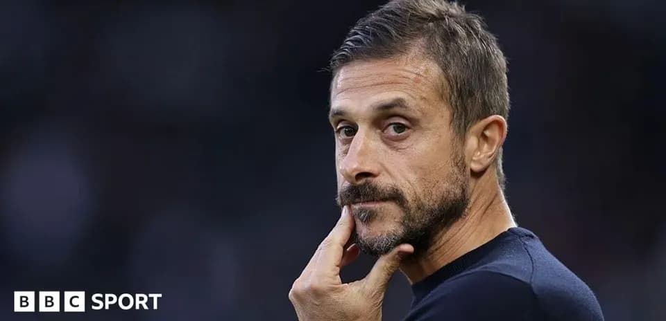 Coach pondering during match on the sidelines