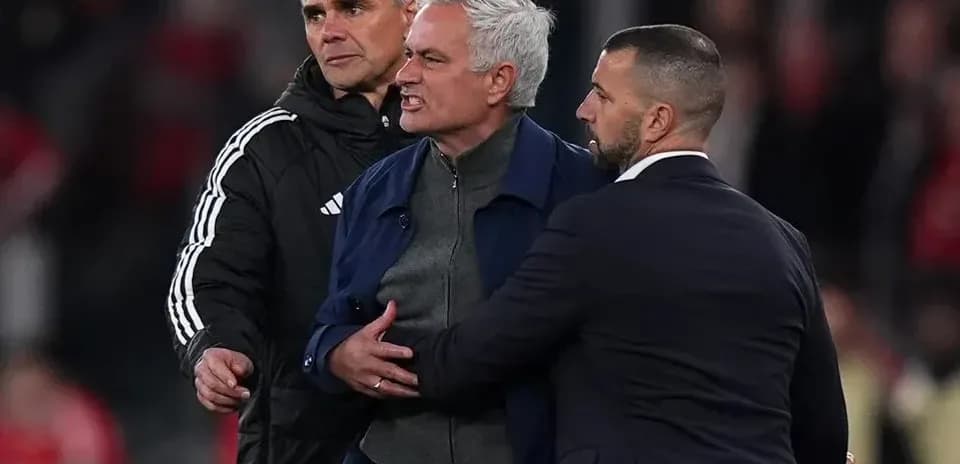 Manager being restrained by staff during match