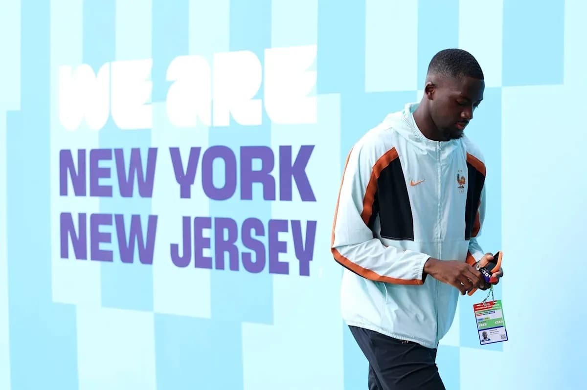Player walking past 'We Are New York New Jersey' sign
