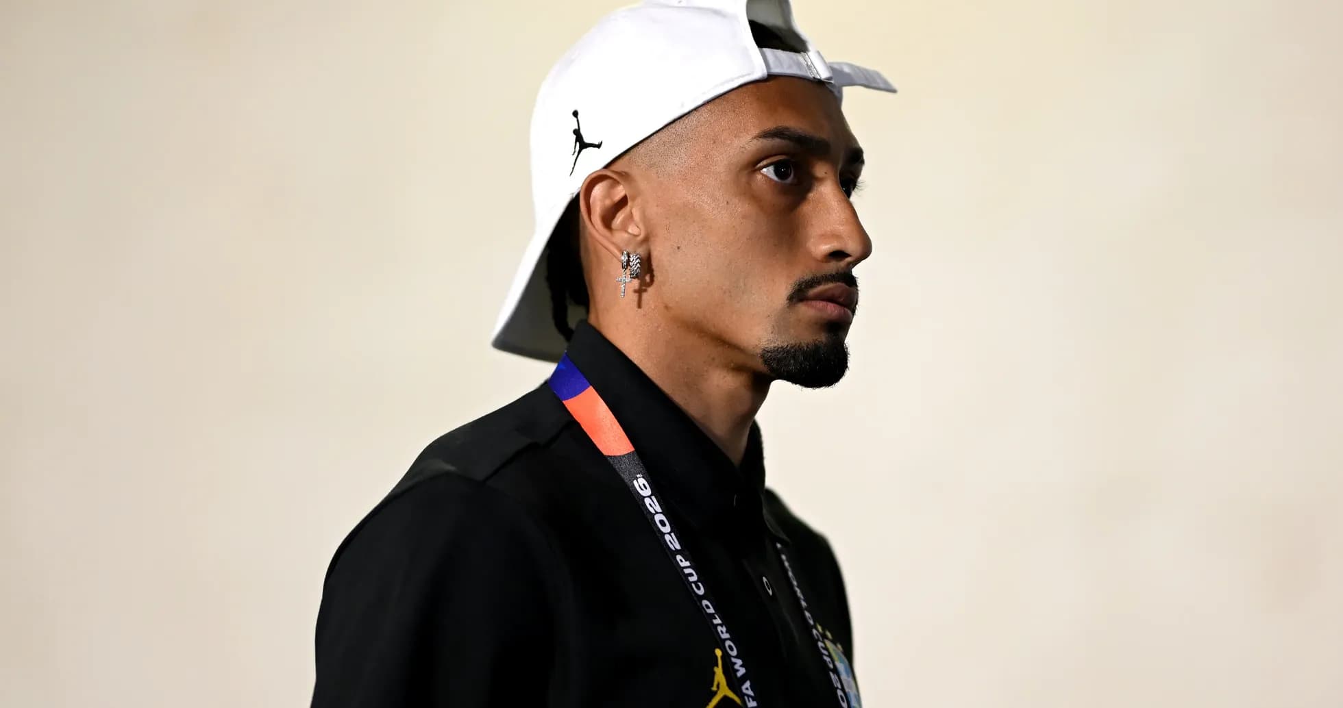 Individual in profile wearing a white cap and shirt