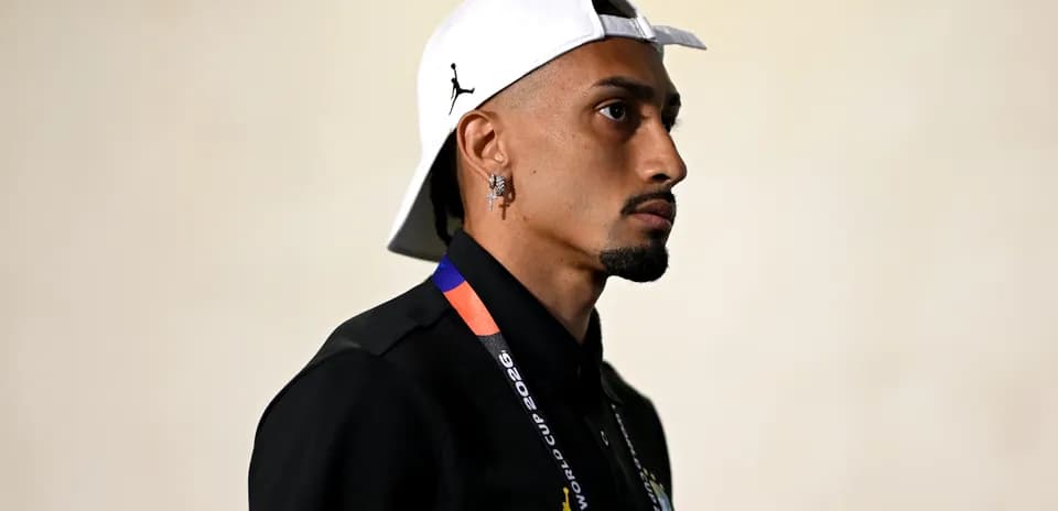 Individual in profile wearing a white cap and shirt