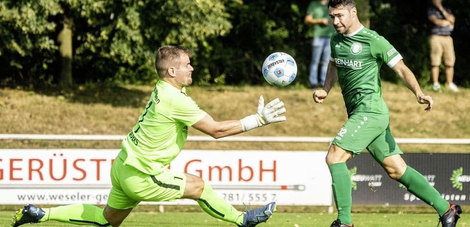 Goalkeeper saving a shot during football match