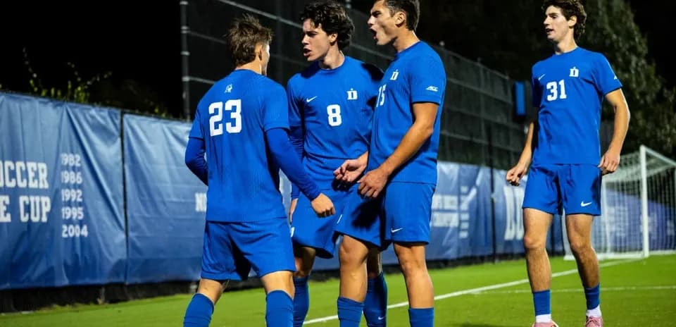 Duke players celebrating a goal on the field