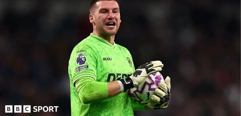 Goalkeeper in green kit holding a football