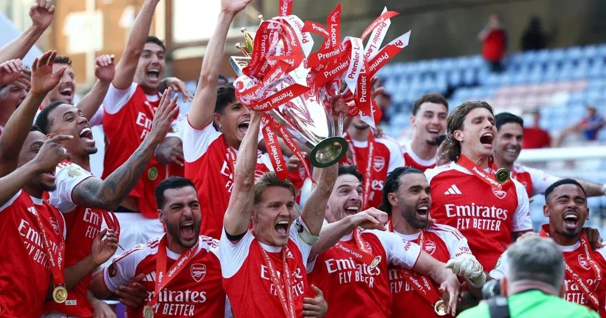 Arsenal players celebrating with Premier League trophy