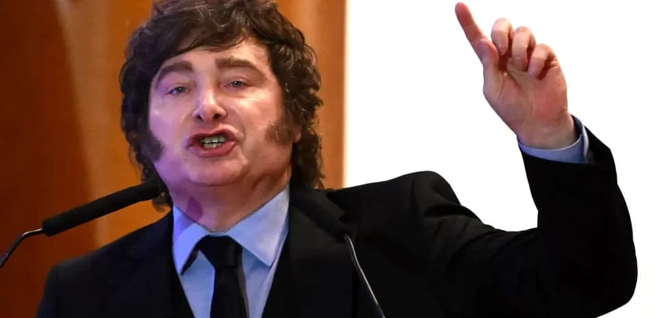 Man speaking passionately at podium with microphone