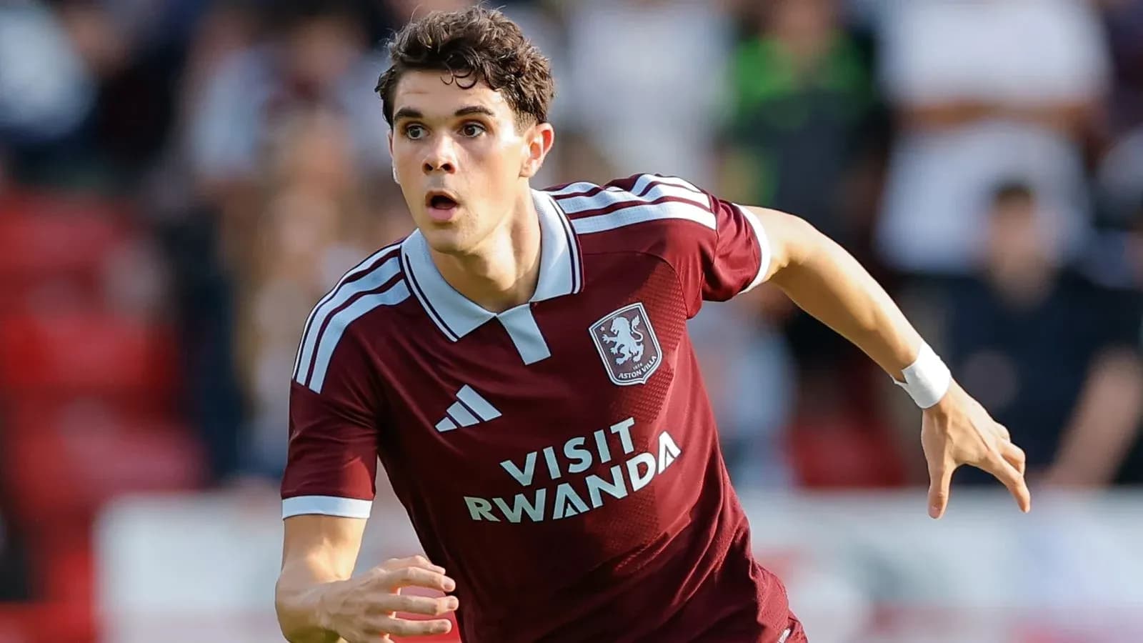 Player in maroon kit running during match