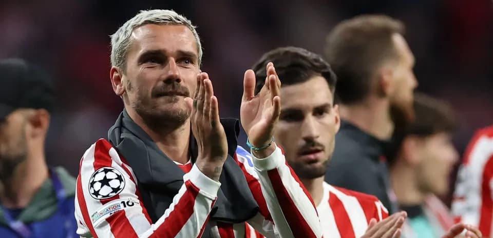 Player applauding fans after match with teammates