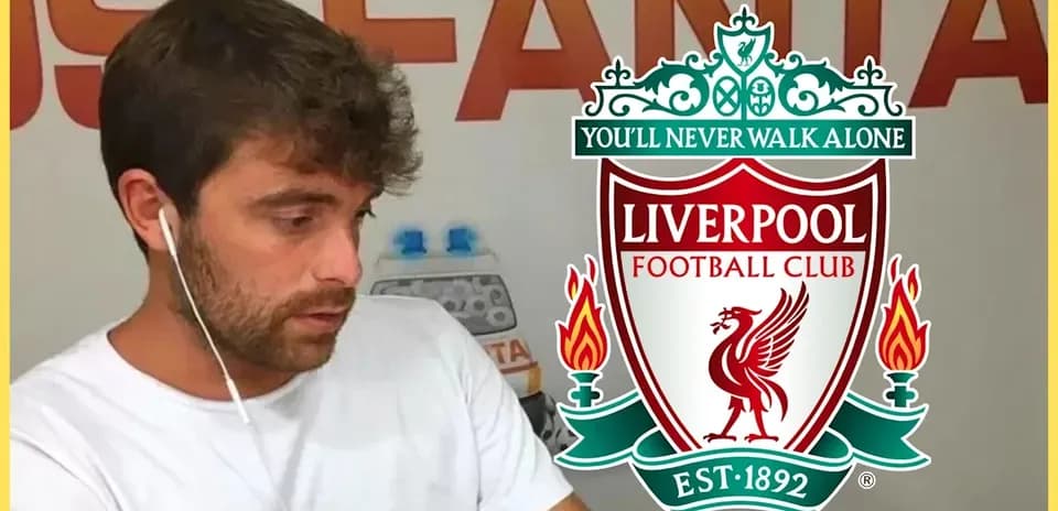 Person wearing headphones with Liverpool FC logo background