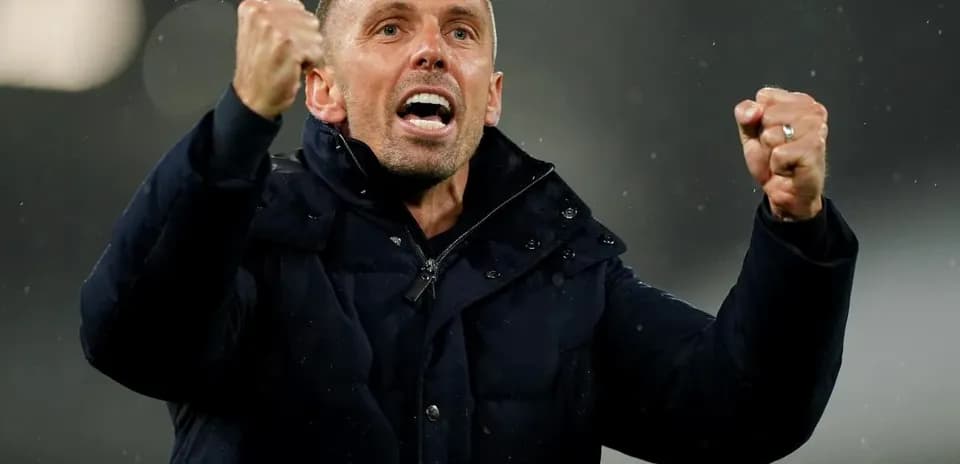 Coach celebrating with clenched fists during match