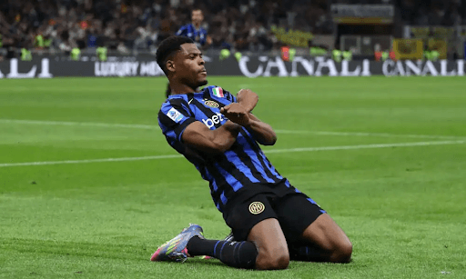 Player celebrating on the pitch after scoring goal
