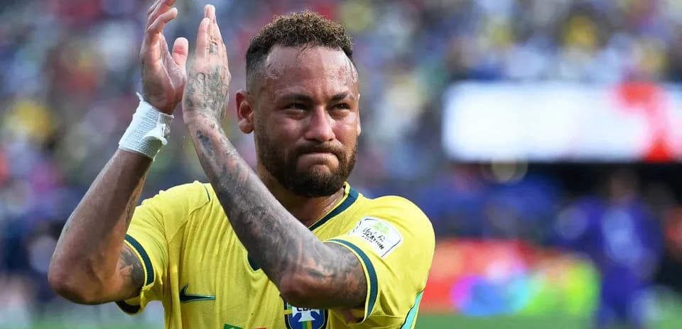 Player in Brazil jersey applauding fans after match
