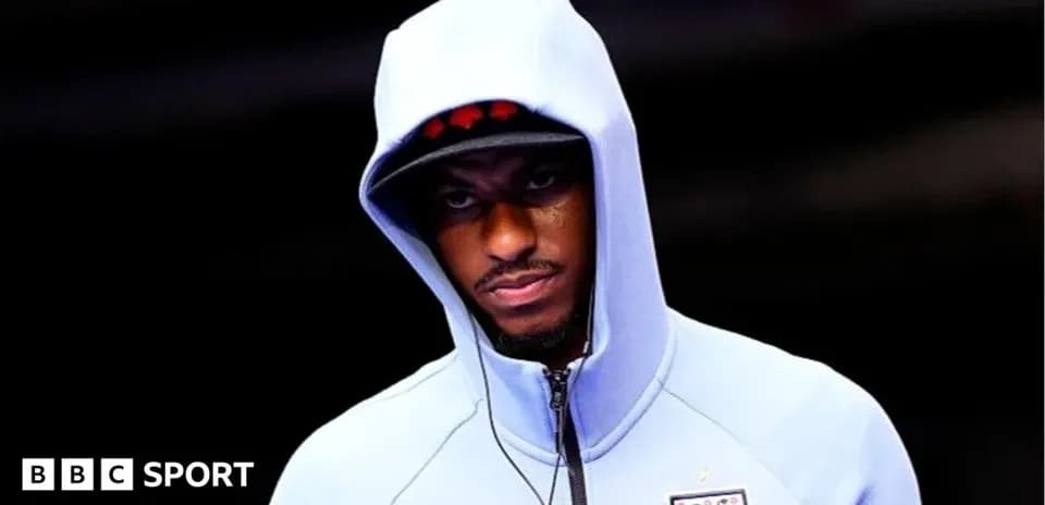 Player wearing a hooded sweatshirt before a match