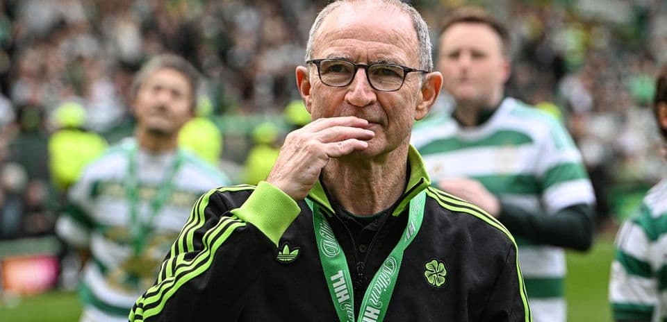 Manager celebrating with players on the pitch