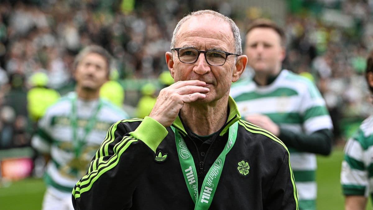 Manager celebrating with players on the pitch