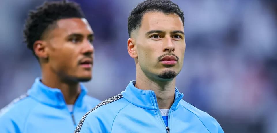 Two players in blue training jackets before match