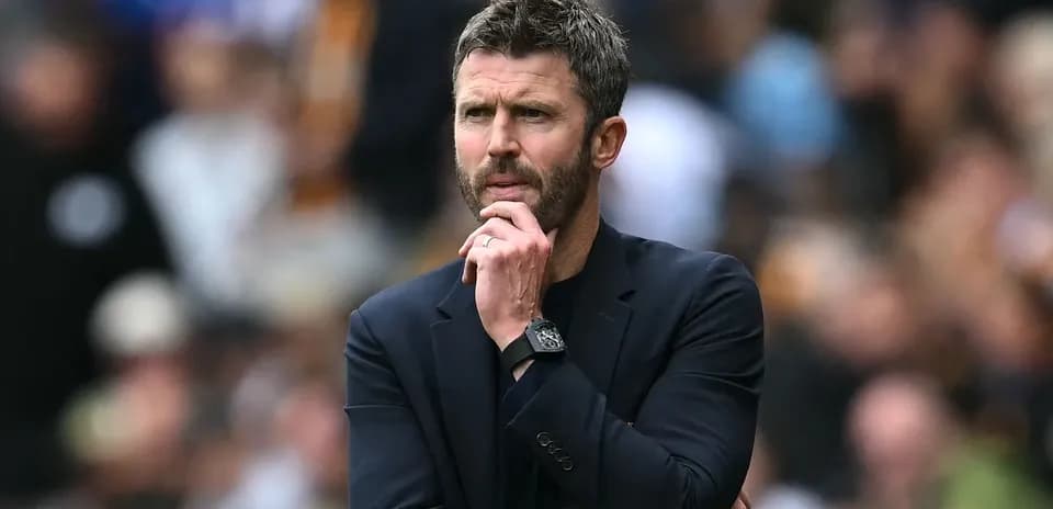 Coach observing the game with a thoughtful expression