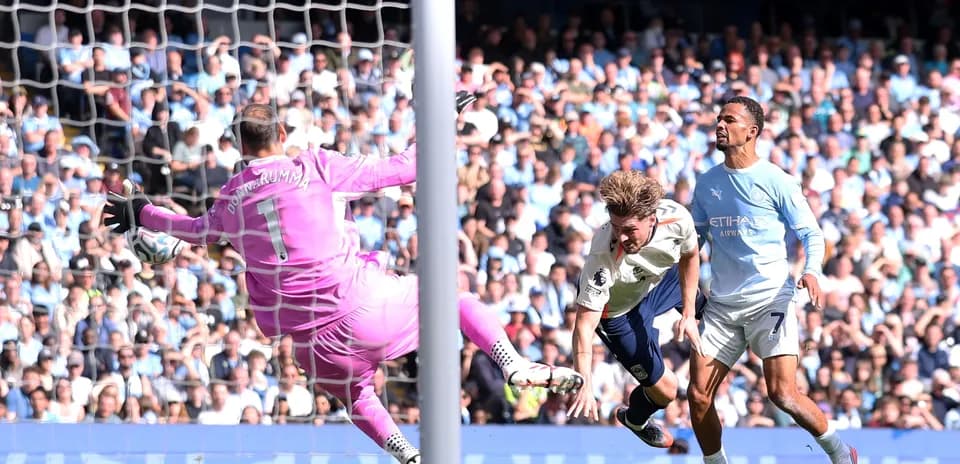 Player attempting to score as goalkeeper dives