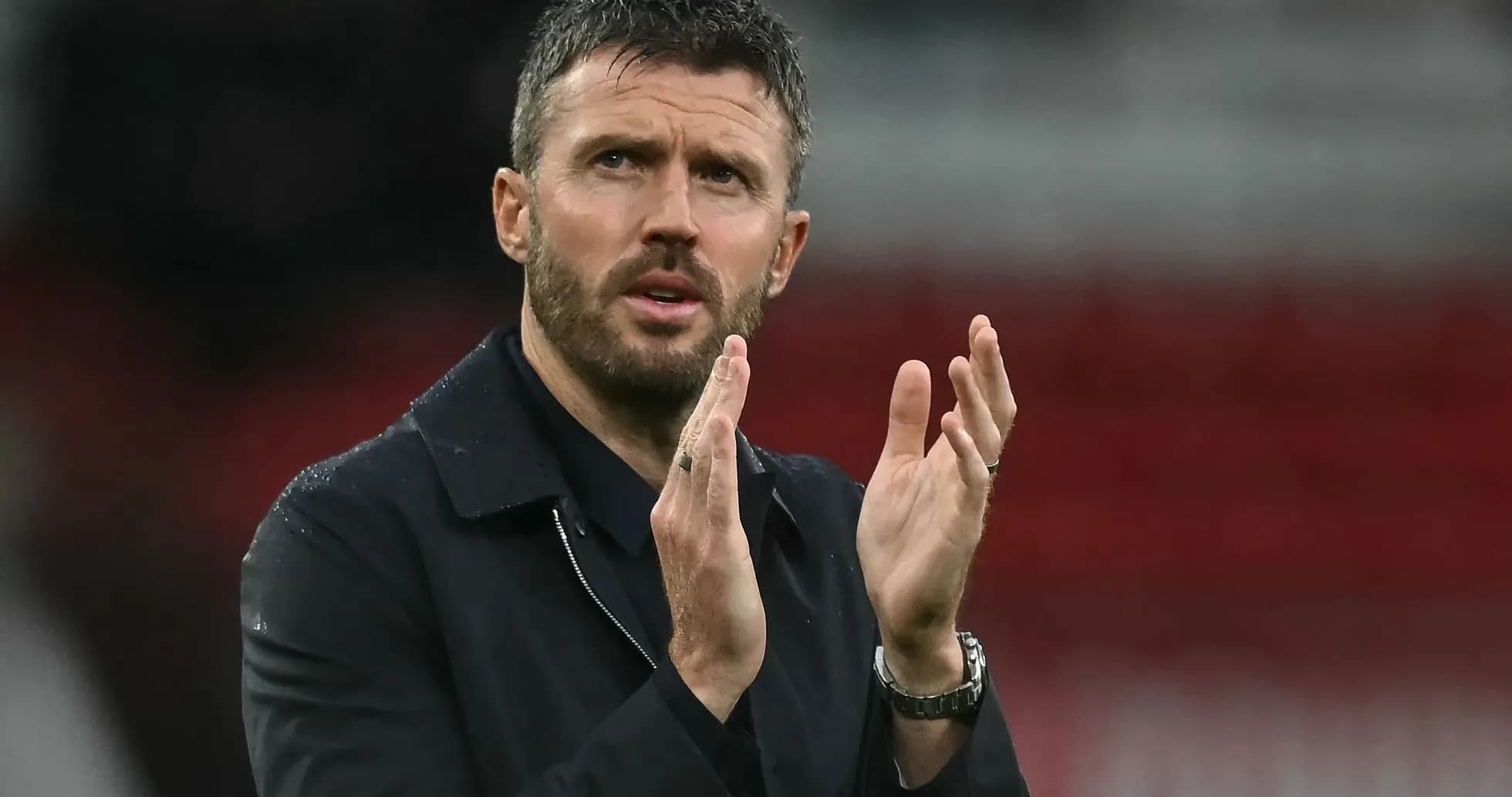 Coach applauding during a match on the sideline