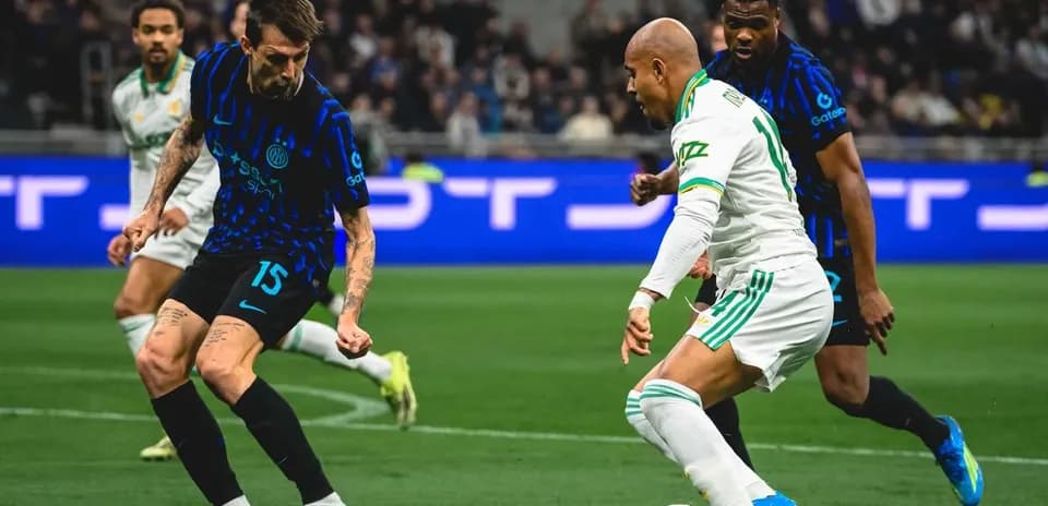 Inter player challenges AS Roma midfielder during match