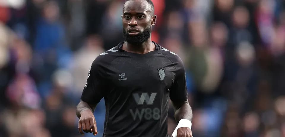 Player in black kit during a football match