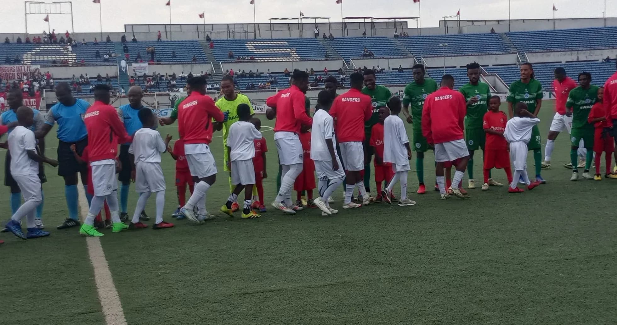 Players of Barau FC and Enugu Rangers shaking hands