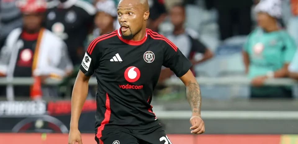 Player in black jersey running on the field