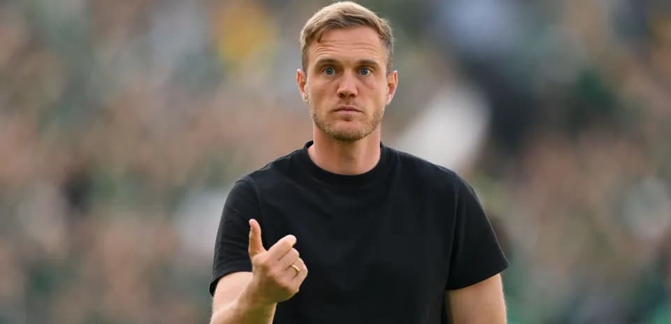 Coach gesturing during a match on the sidelines