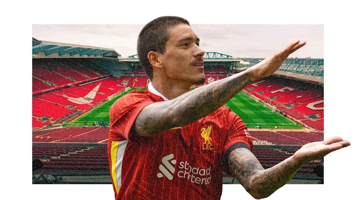 Player gesturing in front of Anfield stadium