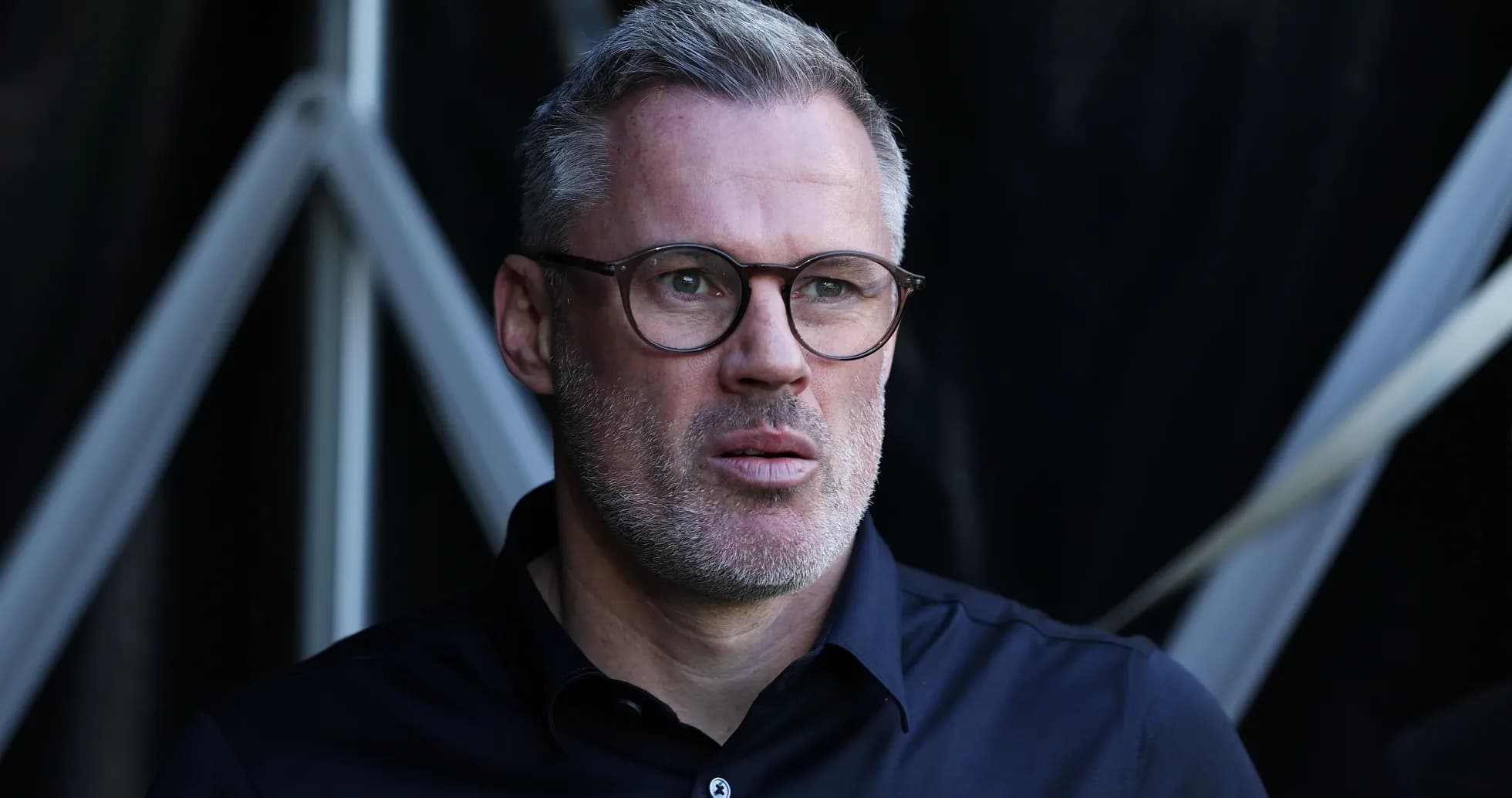 Man with glasses looking intently off-camera