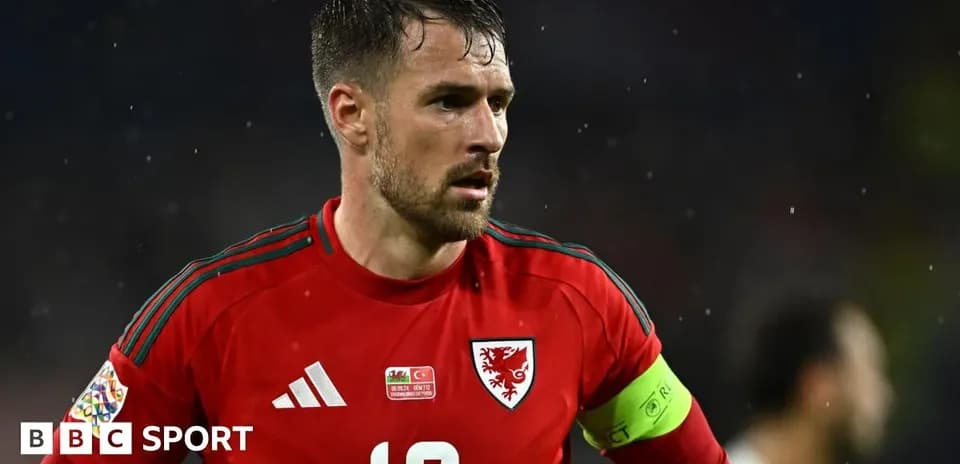 Wales player wearing red kit during match