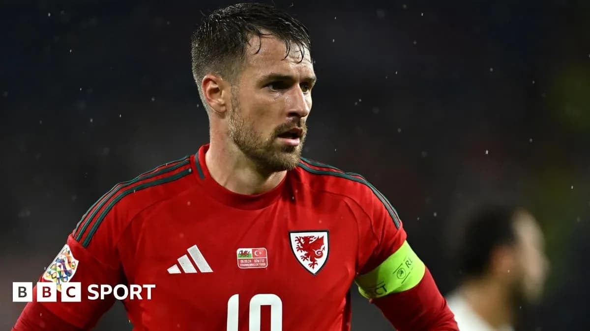 Wales player wearing red kit during match