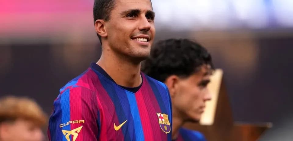 Player smiling in FC Barcelona kit during ceremony
