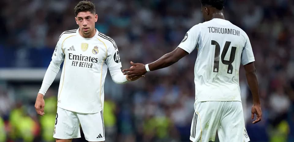Real Madrid players exchanging a handshake on field